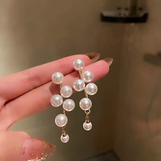 Éblouissantes boucles d'oreilles en or avec perles raffinées
