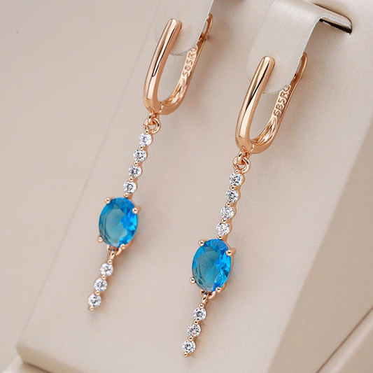 Boucles d'oreilles pendantes élégantes en or ornées de scintillants zircons bleus
